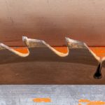 Close-up of circular saw blade teeth on a power saw, a tool part that may be examined in a product defect investigation